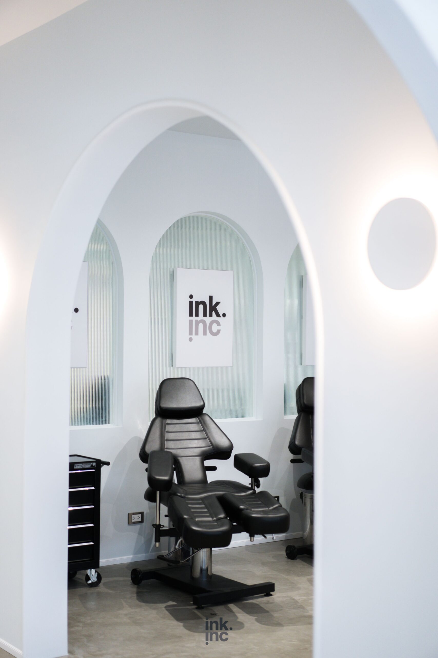 Clean and sterile tattoo station with a modern black chair.