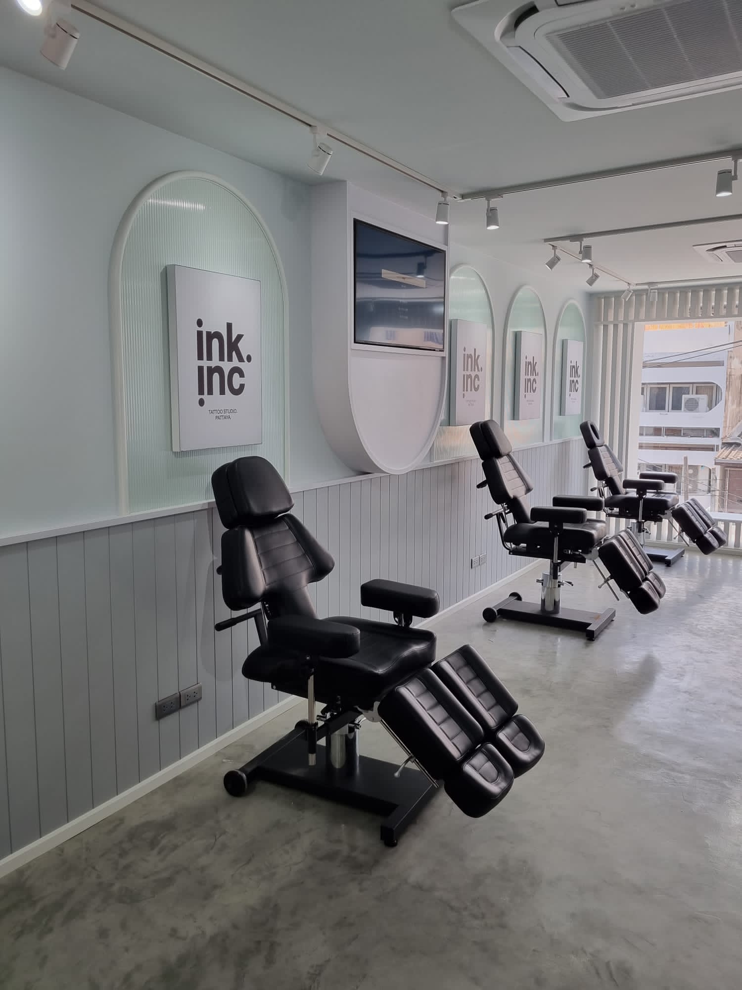 Clean and sterile tattoo station with a modern black chair.